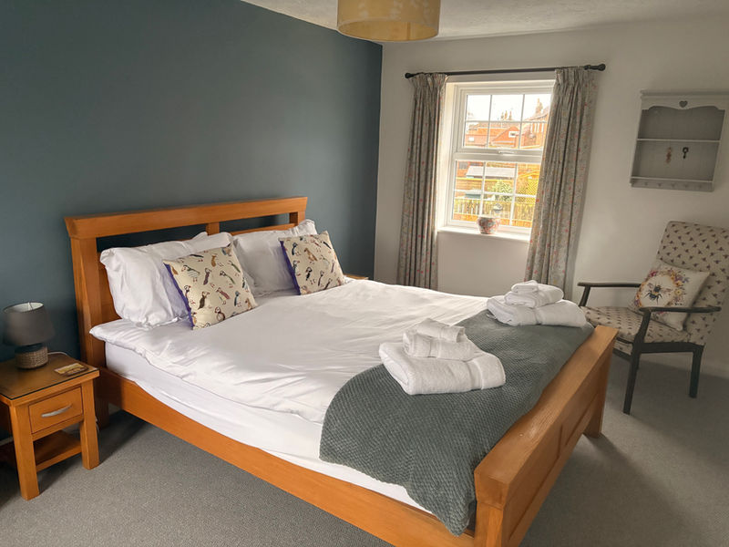 Cosy master bedroom with king-size bed and fluffy white towels